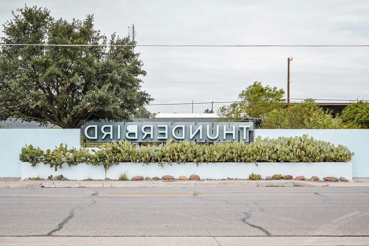 united states teal wall with Thunderbird signage marfa